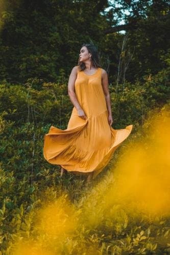 Empowerment photoshoot in a field at golden hour